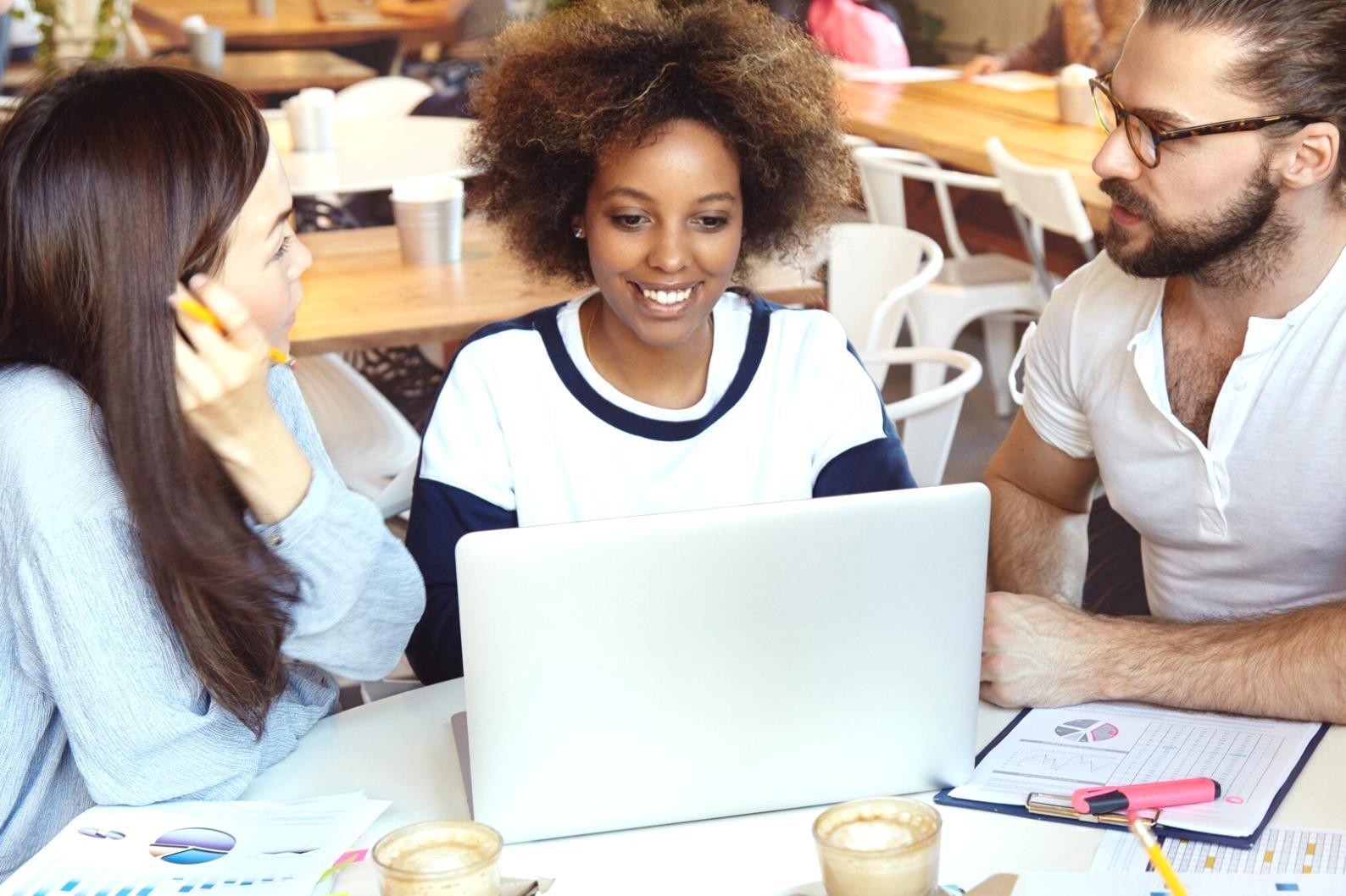 Team member reviewing test cases on multiple devices showing real-world testing scenarios