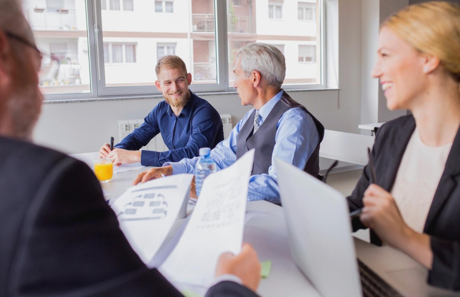 Students working on software testing projects with laptops and documentation